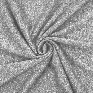 Macro detail of breathable grey sports fabric showing premium texture and spiral drape