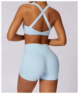 Detail of light blue sports set with cross-back sports bra and high-waisted shorts