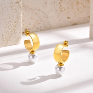French vintage 18K gold C-shape hoop earrings with white pearls on a stone base