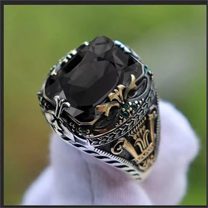 Luxury vintage men's silver ring with black gemstone and gold crown detailing