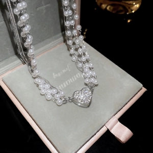 Elegant multi-layer pearl necklace with a sparkling diamond heart pendant in a velvet box