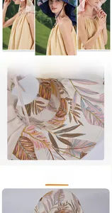 Detail of wide brim sun hat featuring colorful leaf prints and adjustable windproof strap
