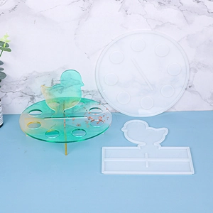 Detail of bird-themed silicone resin molds with a finished blue gradient display stand
