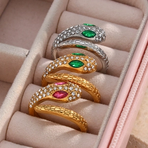 Three gold and silver adjustable snake rings with sparkling crystals in a pink jewelry box