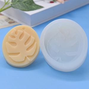 Detail of round silicone mold with monstera leaf pattern for DIY cake and candle making