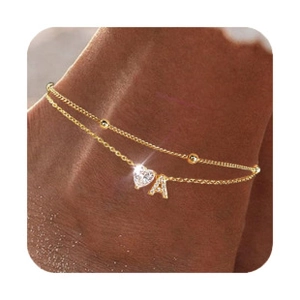 Close-up of golden double-layer anklet featuring heart zircon and letter A pendant