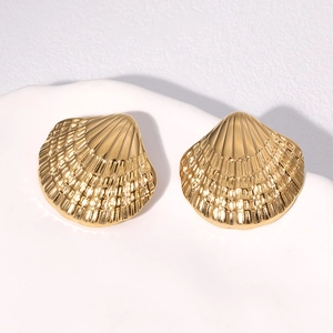 Elegant gold shell stud earrings made of stainless steel displayed on a white tray
