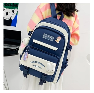 Deep blue and cream school backpack detail with Lucky Sunday text and bear charm