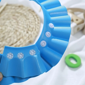 Adjustable blue baby shower cap with wave foam brim and snap fasteners for bath protection