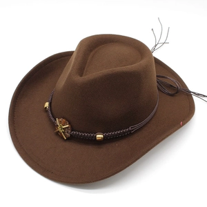 Detailed macro view of dark brown cowboy hat featuring woven band and metal sun ornament