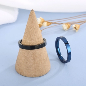 Detail of 3mm flat stainless steel rings in black and blue on a wooden stand