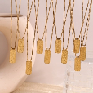 Macro view of gold plated stainless steel tarot number pendants with luxury finish