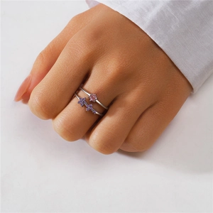 Detail of S925 silver double layer ring set with pink gemstone and purple flower charms