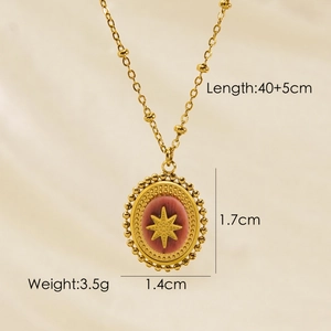 Detailed view of gold beaded chain with red oval pendant and starburst pattern