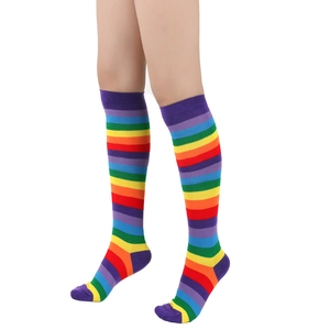 Detail shot of rainbow striped knee high socks on model with vibrant cotton fabric texture