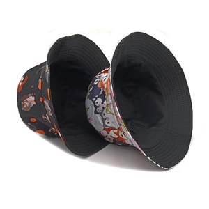 Double-sided reversible bucket hats featuring colorful cute cartoon cat patterns on black canvas