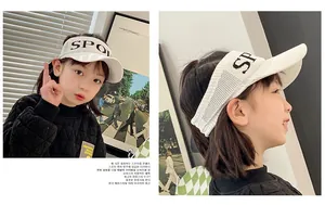 Detail of white knitted visor hat for children with black SPORT embroidery and soft texture