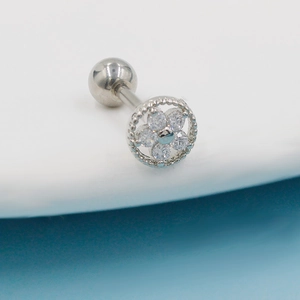 Macro view of silver flower cartilage stud with clear zircons and screw ball back