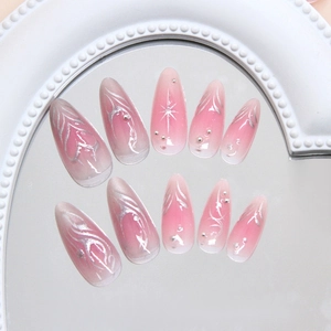Pink gradient almond press-on nails with silver metallic lines and chrome heart details