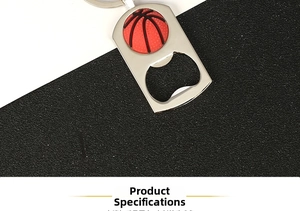 Macro shot of silver metal basketball bottle opener keychain with red and black details
