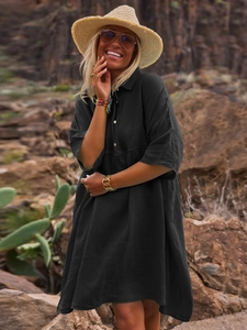 Detail of loose black cotton linen shirt dress with polo collar and buttons