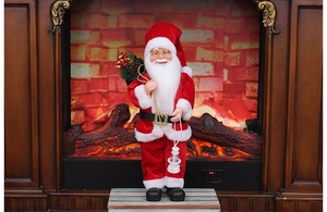 Detailed view of standing Santa Claus with gift bag and lantern in cozy fireplace setting