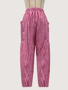 Detail of pink and red striped casual trousers with elastic waist and side pockets