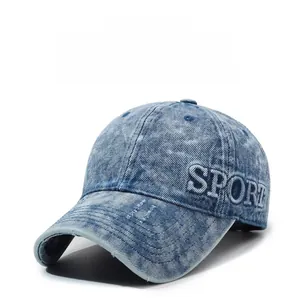 Close-up of thick SPORT letter embroidery on light blue washed denim baseball cap
