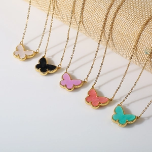 Detail of butterfly pendant necklaces in five colors with gold beaded edge craftsmanship