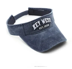 Detail of blue-grey washed cotton sun visor showing Key West vintage embroidery and texture