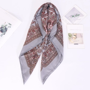Detail of grey vintage paisley cotton linen scarf with ethnic patterns and soft texture