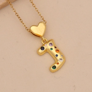 Detailed close-up of gold J-letter pendant with heart link and colorful cubic zirconia