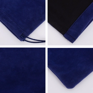Detail view of blue velvet drawstring pouch showing stitching, texture, and black lining
