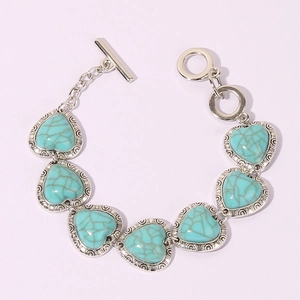 Detailed view of vintage heart bracelet with turquoise stones and a toggle clasp closure