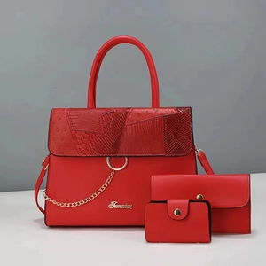 Detailed view of red PU leather three-piece bag set with crocodile and ostrich textures