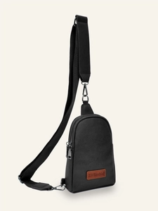 Close-up of black PU leather chest bag with silver hardware and adjustable wide strap