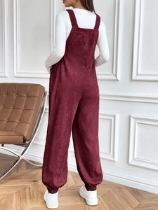 Rear view of burgundy corduroy maternity overalls showing a comfortable, stylish loose fit