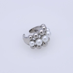 Detailed macro view of an elegant open ring with white pearls and silver metal beads