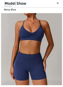 Detail of navy blue V-neck sports bra with ruched front and high waist yoga shorts