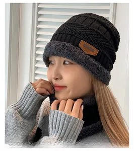 Close-up of winter knit hat and neck warmer with thick faux fleece lining and leather tag