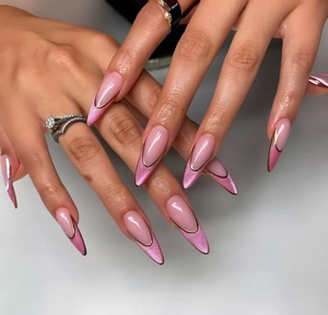 Macro detail of long almond press-on nails with pink cat-eye effect and gold French tips