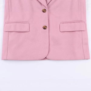 Pink oversized blazer with double-breasted tortoiseshell buttons and flap pockets