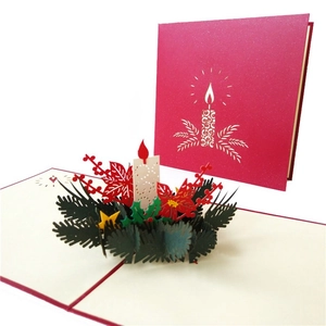 Detail showing 3D pop-up Christmas card with poinsettia flower and candle ornaments