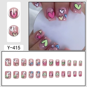 Pink press-on nails with colorful hand-painted hearts and glitter finish set