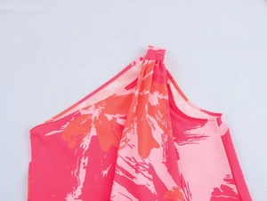 Detailed close-up of pink floral tie-dye pattern on elegant chiffon one-shoulder dress