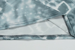 Detailed view of tie-dye hem with geometric print and double-needle stitching quality