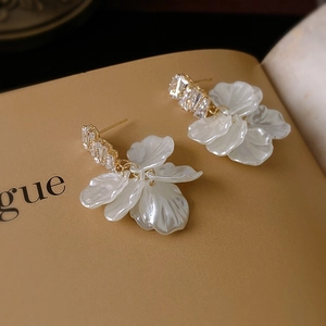 Detailed macro shot of elegant rose petal tassel earrings with sparkling cubic zirconia studs