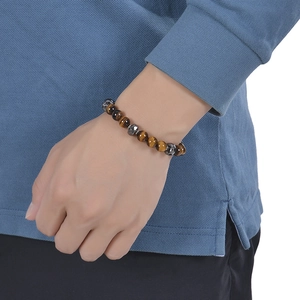 Men's Tiger Eye beaded bracelet with stainless steel accents worn on a male wrist