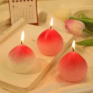Realistic peach scented candles on books with tulips for home decor and gift