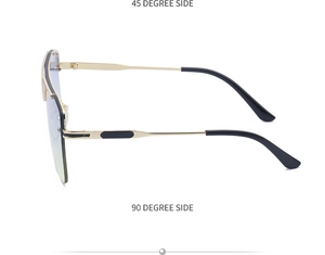 Detail view of large frame sunglasses with golden metal temples and light blue lenses